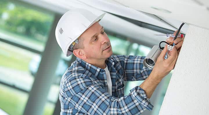 man installing a security camera system